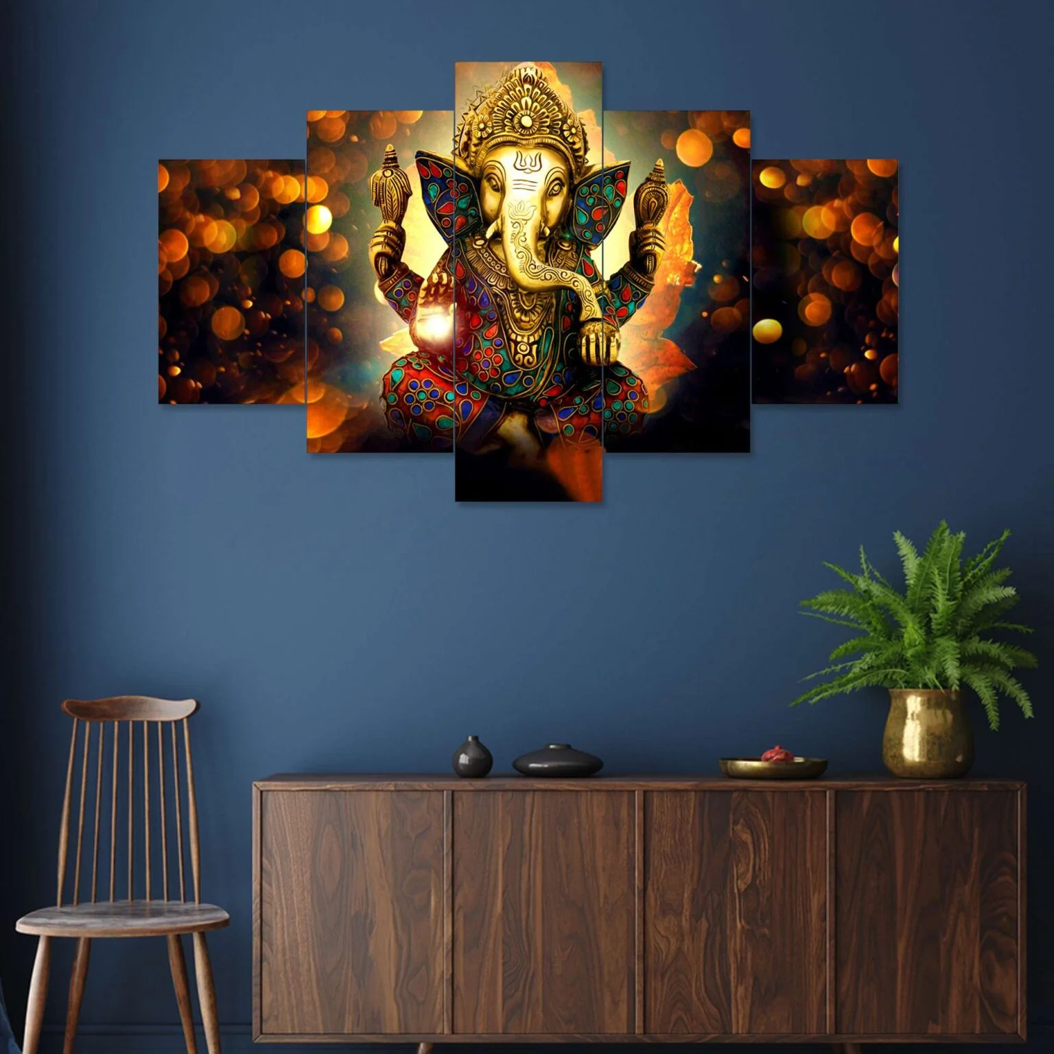 Decor Home Craft A Decor Home Ganesha 24x50in wall painting with intricate design hangs above a wooden cabinet in a living room with a dark blue wall, complemented by a wooden chair and a potted plant on the side.