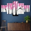 Decor Home Craft A Nature set of 5 framed 24x50" wall paintings depicting a stylized pink cherry blossom tree with a black silhouette of a bird perched on a branch, mounted on a deep blue wall above a wooden cabinet with a potted plant in an office.