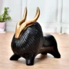 Decor Home Craft Decorative sculpture of a Multi color Yak Showpiece to decorate Living room Home Office 30x30" R-BD3 with glossy golden horns, displayed on a light wooden table in a hotel lobby against a softly blurred background.